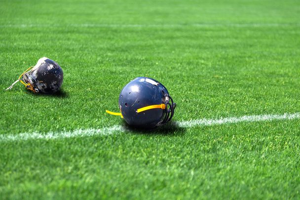 Helmet rugby lying in the field - Foto, immagini
