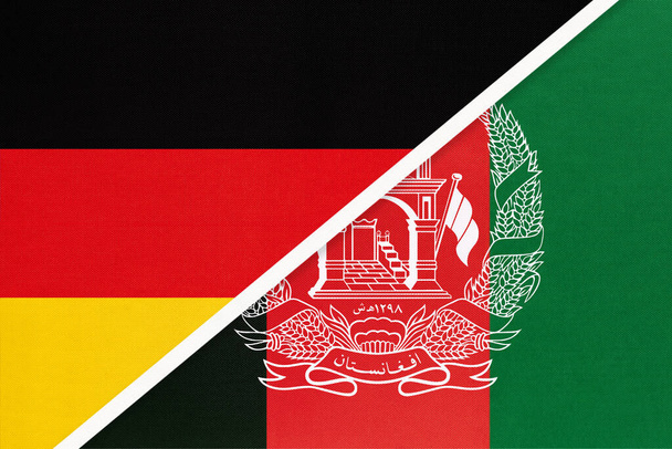 Németországi Szövetségi Köztársaság kontra az Afgán Iszlám Köztársaság, két nemzeti zászló szimbóluma textilből. Az európai és ázsiai országok közötti kapcsolat, partnerség és bajnokság. - Fotó, kép