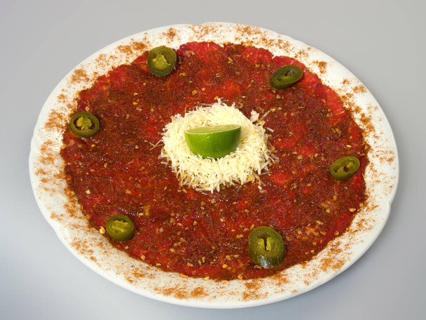 Vegetable soup with grated cheese garnished with lime and olives. - Photo, Image
