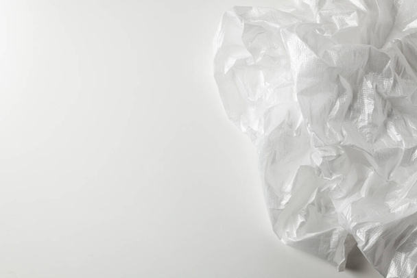 Squeeze a crumpled foam sheet isolated on white background with copy space. - 写真・画像