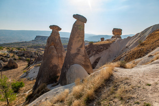 Rocks looking like mushrooms dramatically  in Cappadocia, Turkey This photo was shot from Cappadocia which located in the center of Turkey. Cappadocia is an ancient region of Anatolia.  - Φωτογραφία, εικόνα