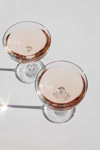 Glass of sparkling wine on the white table - 写真・画像