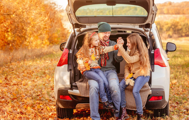 Father with daughters in autumn surroundings - Photo, Image