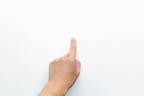 The person's hand points and presses with the index finger of the left hand on an empty white copy space. Business and technology concepts - 写真・画像
