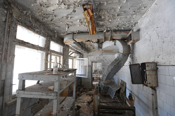 Kitchen in abandoned school in ghost town Pripyat, post apocalyptic interior, Chernobyl zone, Ukraine - Photo, Image