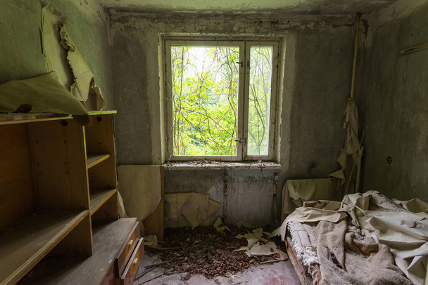 Abandoned apartment in ghost town Pripyat, post apocalyptic interior, shabby wallpaper, Chernobyl zone, Ukraine - Zdjęcie, obraz