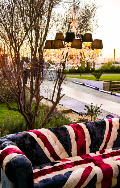 Union Jack British Flag couch with suspended chandelier at outdoor corporate event - Photo, image