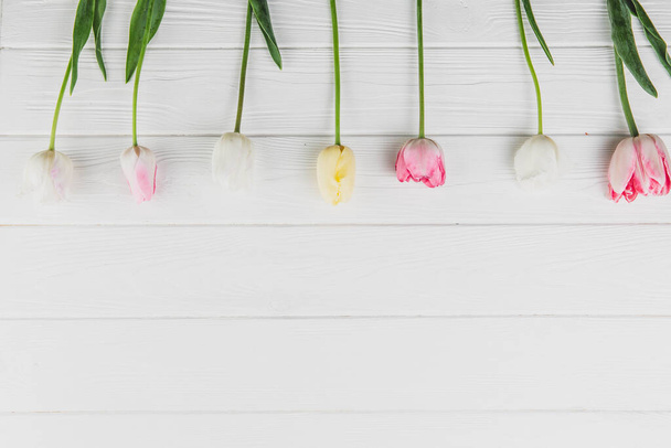 Women's day. Tulips bouquet on white wooden background. - Fotó, kép