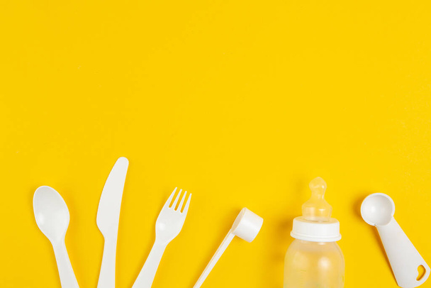 Children's plastic tableware on a yellow background - Foto, Imagem
