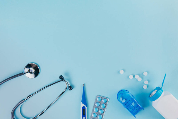 Medical equipment and pills on a blue background - Фото, зображення