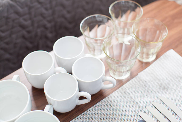 Tableware such as cups and plates placed on the table - Foto, Imagem