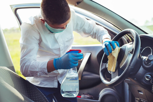 Disinfecting inside car, wipe clean surfaces that are frequently touched, prevent infection. - Foto, Imagem