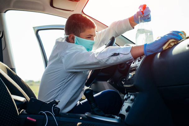 Disinfecting inside car, wipe clean surfaces that are frequently touched, prevent infection. - Photo, image