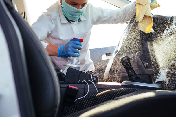 Cleansing car interior and spraying with disinfection liquid. Prevent infection of Covid-19 virus coronavirus. - Φωτογραφία, εικόνα