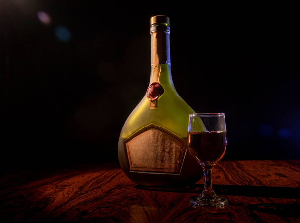 Still life of a liquor bottle in low light. - Photo, Image