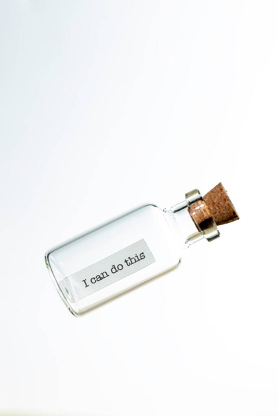 glass bottle with a message inside  and cork tap on a white background - Foto, immagini
