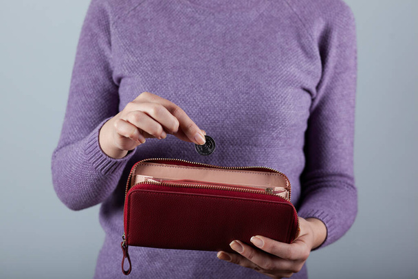 young woman hand holding  coin with wallet  - Fotoğraf, Görsel