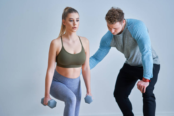 Woman with her personal fitness trainer - Photo, Image
