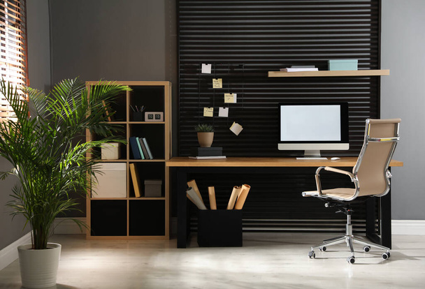 Comfortable workplace with computer and office chair. Stylish room interior - Φωτογραφία, εικόνα