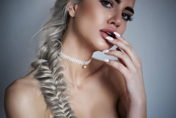 Perfect beauty girl portrait with totally blonde hair pigtail and perfect makeup work with camera and posing - Foto, immagini