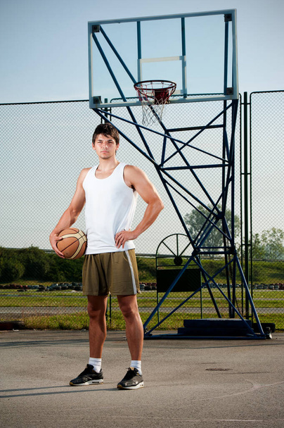 Young Sports Men Playing Basketball Outdoors on a Sunny Day - Фото, изображение