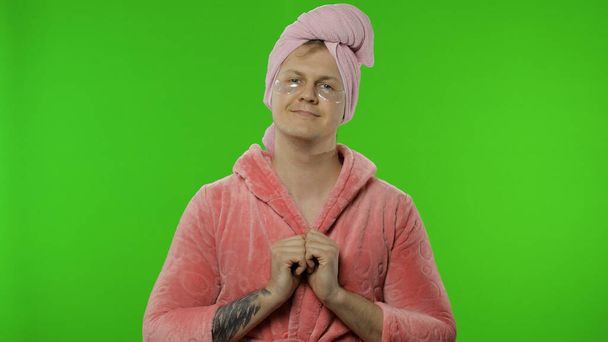 Portrait of transsexual man in bathrobe with eye patches. Chroma key - Photo, Image