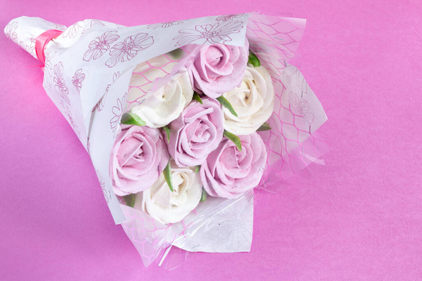 Bouquet of edible roses made from marshmallows on a pink background. Romantic food. Sweet present. Copy space. - Photo, Image
