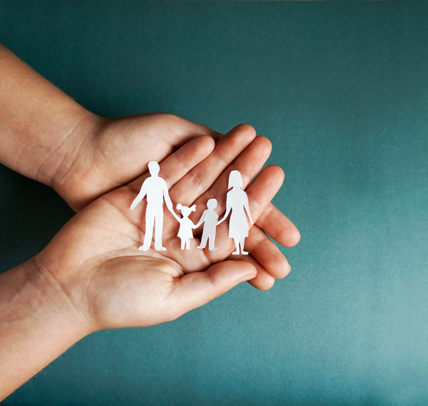 hands holding paper family cutout, social distancing concept, covid19 on the blue color background - Photo, Image