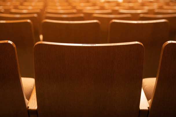 Wooden audience seats lined up in an empty movie theater - Photo, Image