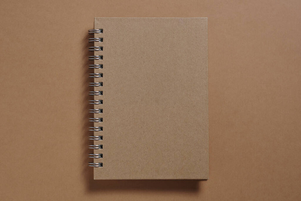 Brown notebook with spiral close-up, top view - Foto, immagini