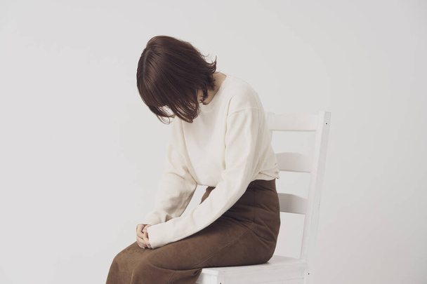 Aasialainen nuori nainen masentunut ja laskenut piilottaa kasvonsa hiuksillaan
 - Valokuva, kuva