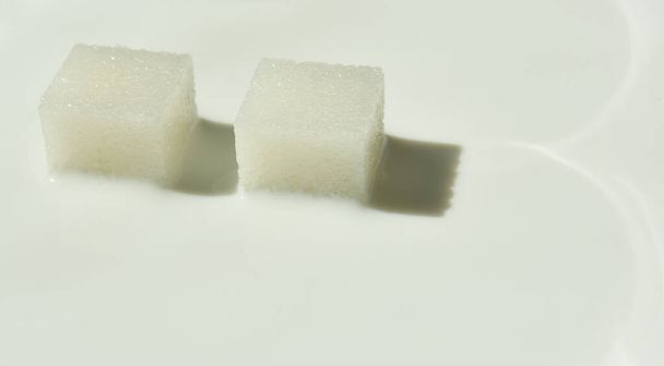 white sugar cubes in milk - Photo, Image