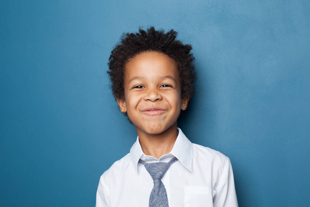 Happy black child boy on blue background - Φωτογραφία, εικόνα