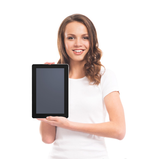 A happy teen girl holding a tablet computer - Фото, изображение