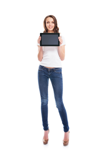 A happy teen girl holding a tablet computer - Zdjęcie, obraz