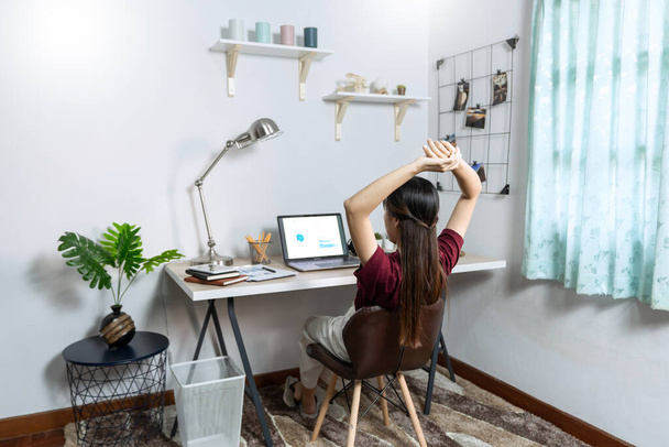 Attractive young beautiful asian woman Entrepreneur or freelancer working at home with laptop business reports and online communications on living room sofa, working remotely access concept - Fotoğraf, Görsel