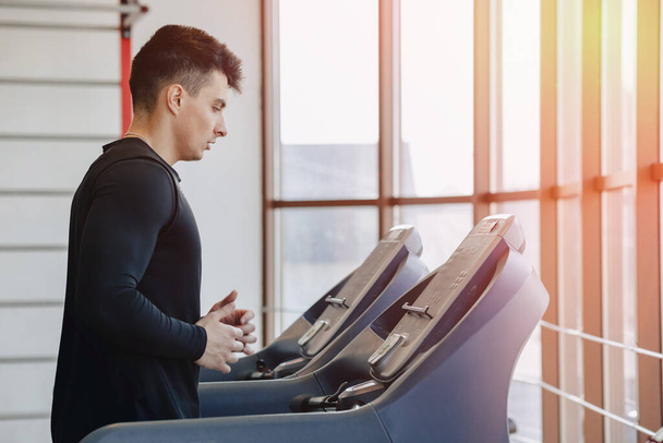 stylish guy in the gym is training on the treadmill. Healthy Lifestyle. wellness. - Foto, imagen