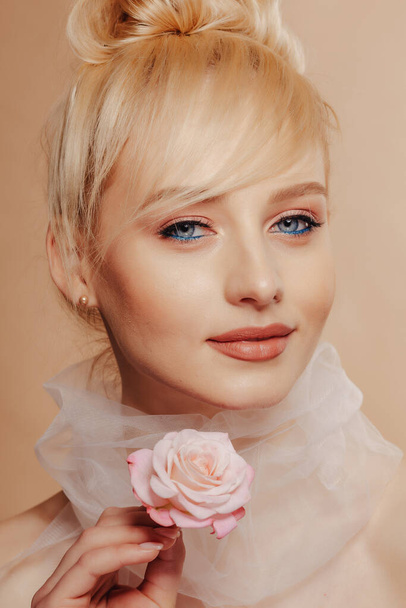 pretty attractive girl with blond hair, fashion shooting, rose, simple background, studio - Фото, зображення