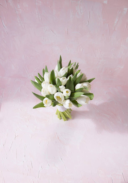 ramo de tulipanes blancos. El mango del racimo está decorado con encaje de algodón. blanco y colores rosados polvorientos
. - Foto, Imagen