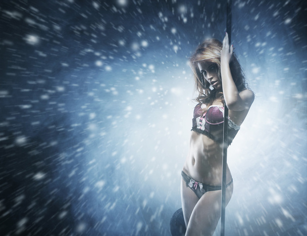 Beautiful and sexy striptease dancer over the smoky background - Zdjęcie, obraz