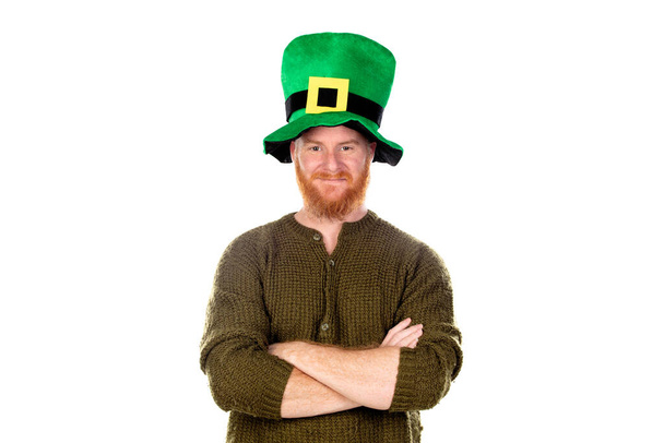 Red haired guy with green hat looking at camera isolated on a white background - Photo, Image