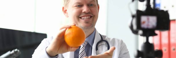Nutritionist doctor speaks about benefits orange - Photo, Image