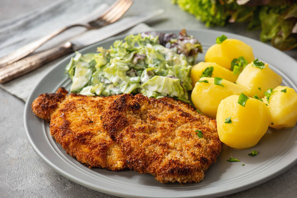 Chop pork cutlets , served with boiled potatoes and salad. - Photo, image