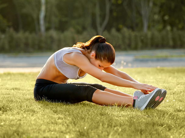 Portrait of Young Sporty Woman Doing Stretching Exercise. - Foto, Imagem