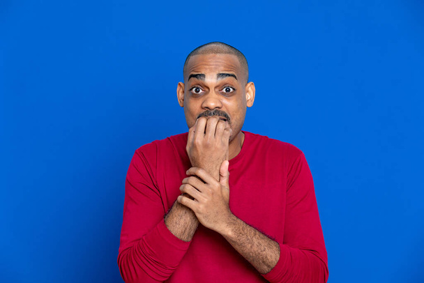African man with red T-shirt on a blue background - Photo, Image