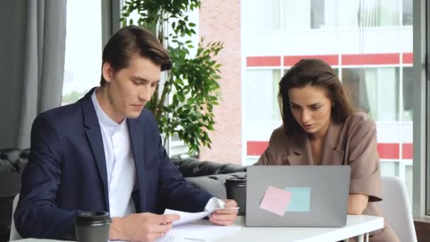 Man and woman work in comfortable modern office with laptop. Working process. Confident businesswoman professional manager talk to male client at meeting - Materiał filmowy, wideo