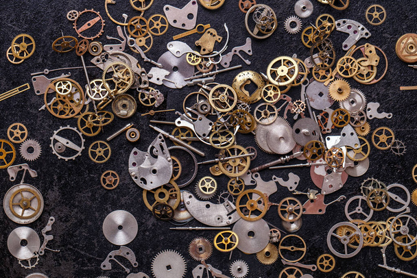 Details, technology. Heap of small gears on the table - Photo, Image