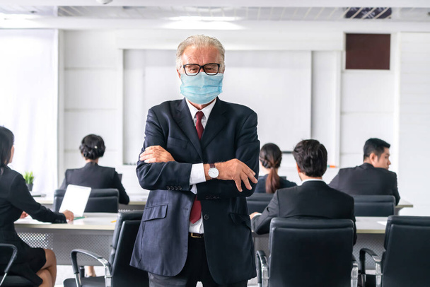 Zaufani biznesmeni z maską na twarzy chronią się przed Coronawirusem lub COVID-19. Koncepcja pomocy, wsparcia i współpracy w celu przezwyciężenia epidemii koronawirusu lub COVID-19 w celu ponownego otwarcia działalności gospodarczej. - Zdjęcie, obraz