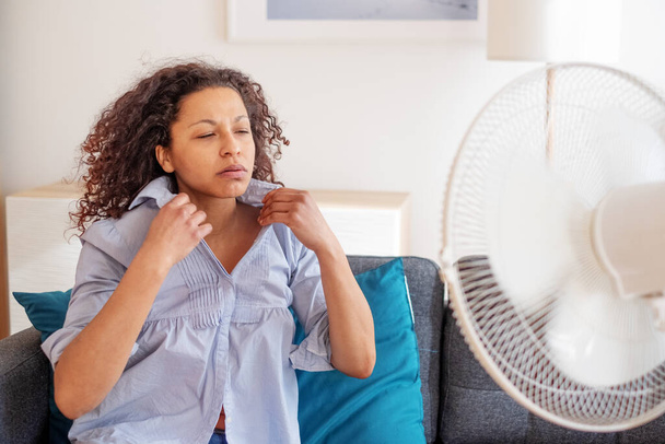 Black woman portrait cooling off at home during summer heat - Φωτογραφία, εικόνα