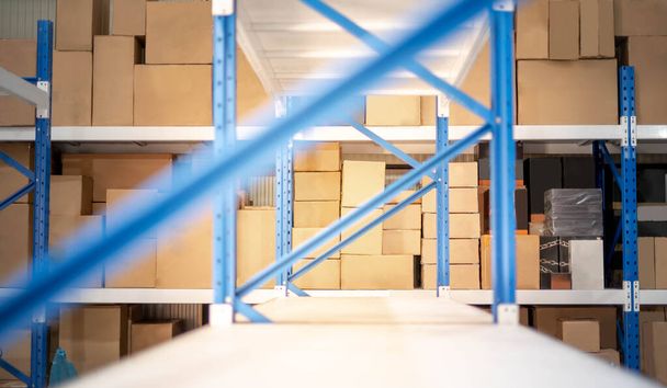 Le bleu du support métallique se préparent à l'assemblage dans l'entrepôt ou le stockage et les étagères pour mettre des boîtes en carton de produits
. - Photo, image